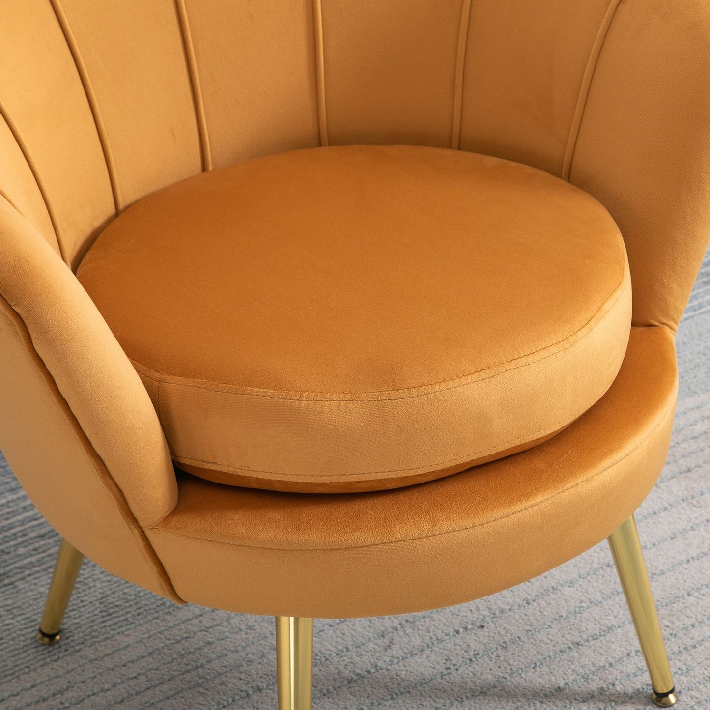 Upholstered shell-shaped armchair with metal legs, yellow
