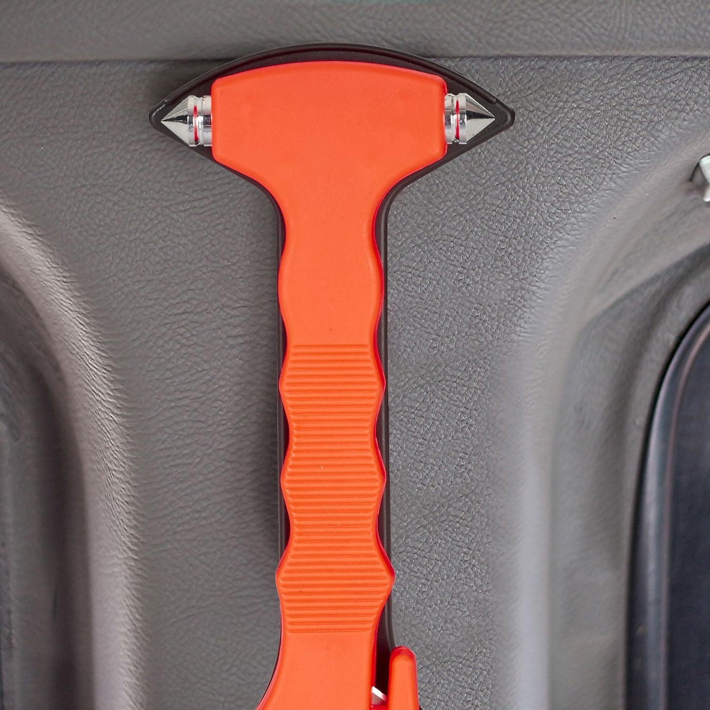 Car with emergency hammer and seat belt cutter