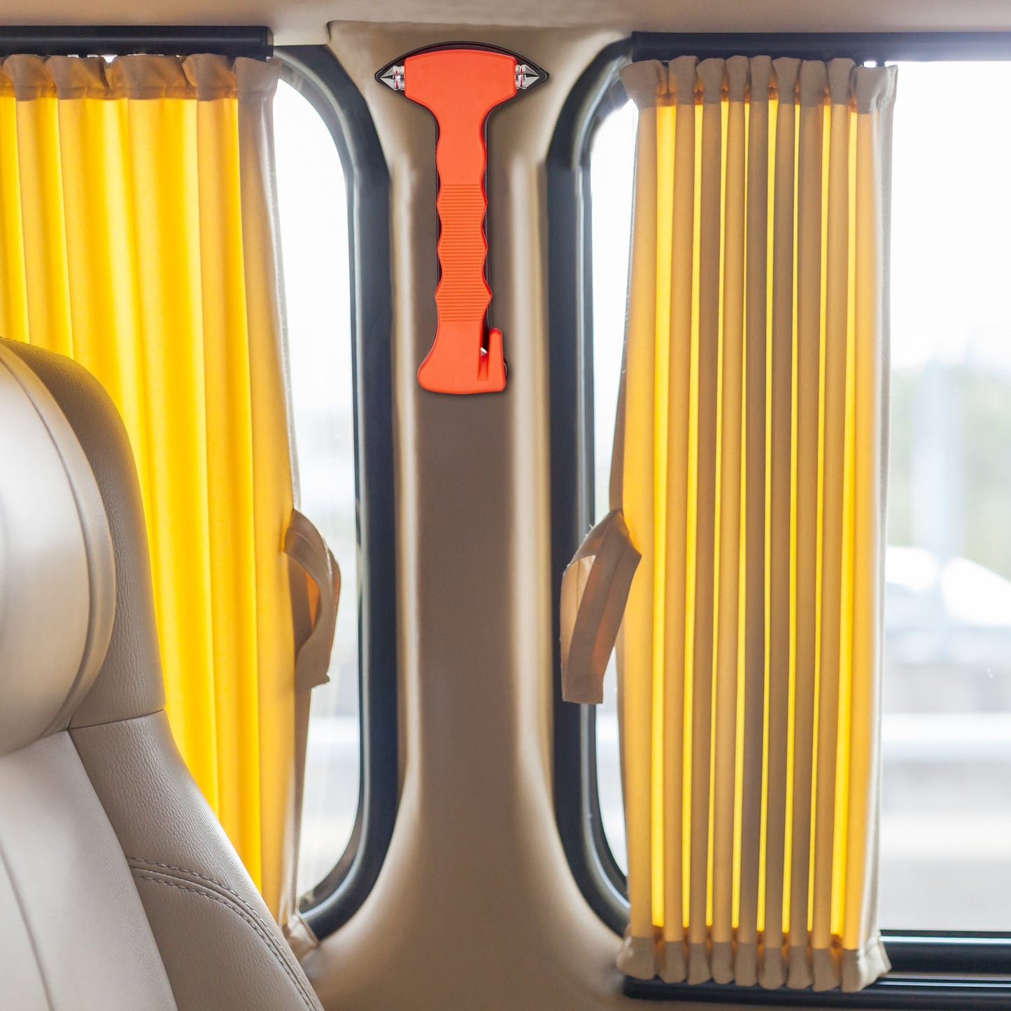 Car with emergency hammer and seat belt cutter