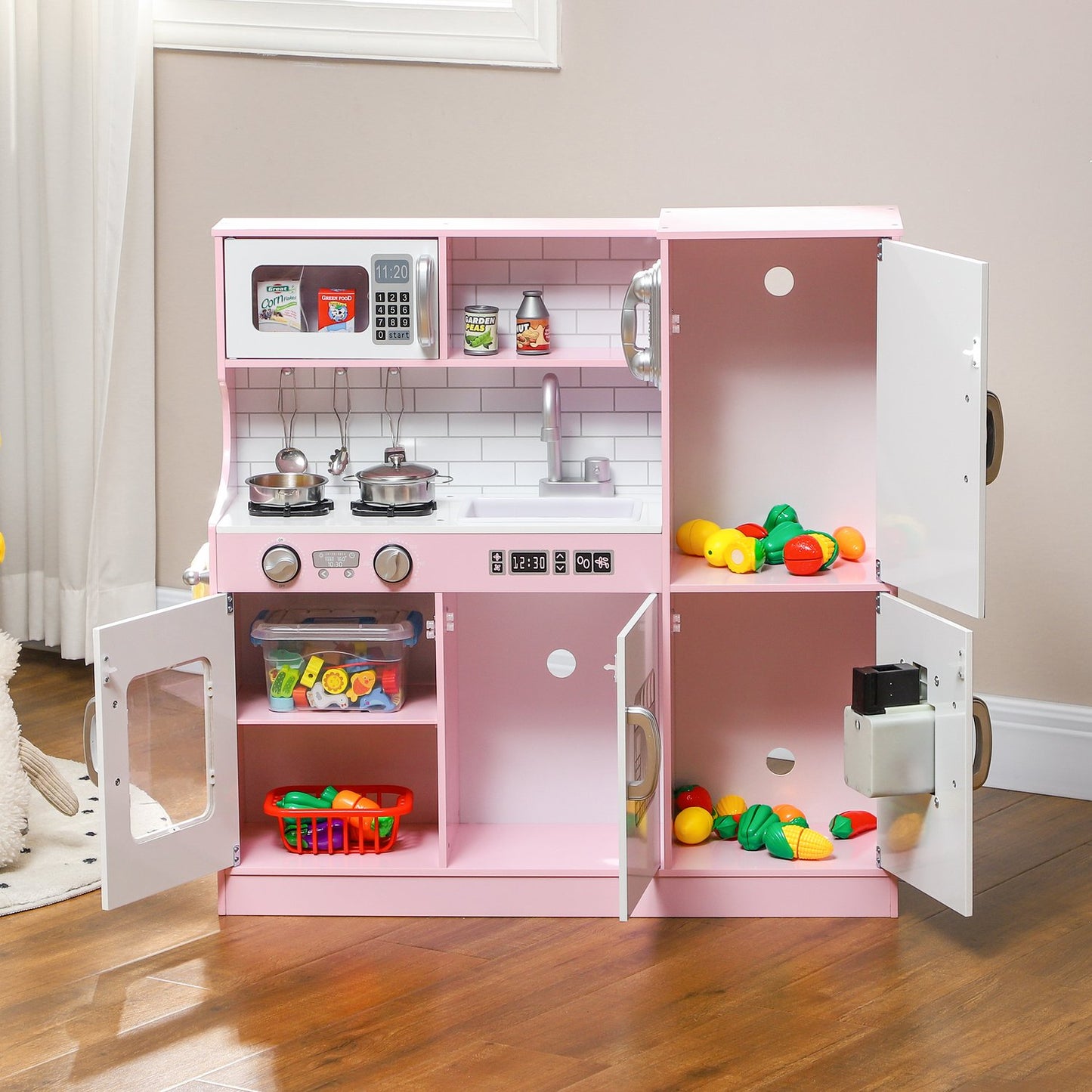 Pink play kitchen for children with toy phone and accessories