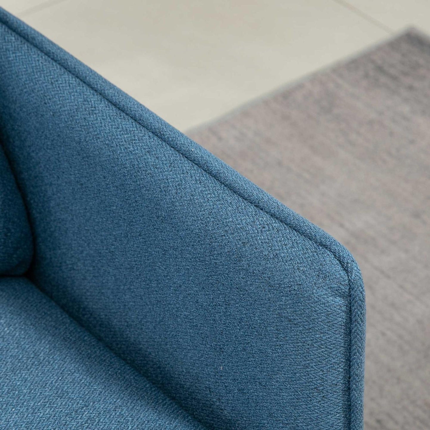 Modern dark blue 2-seater sofa with thick cushions