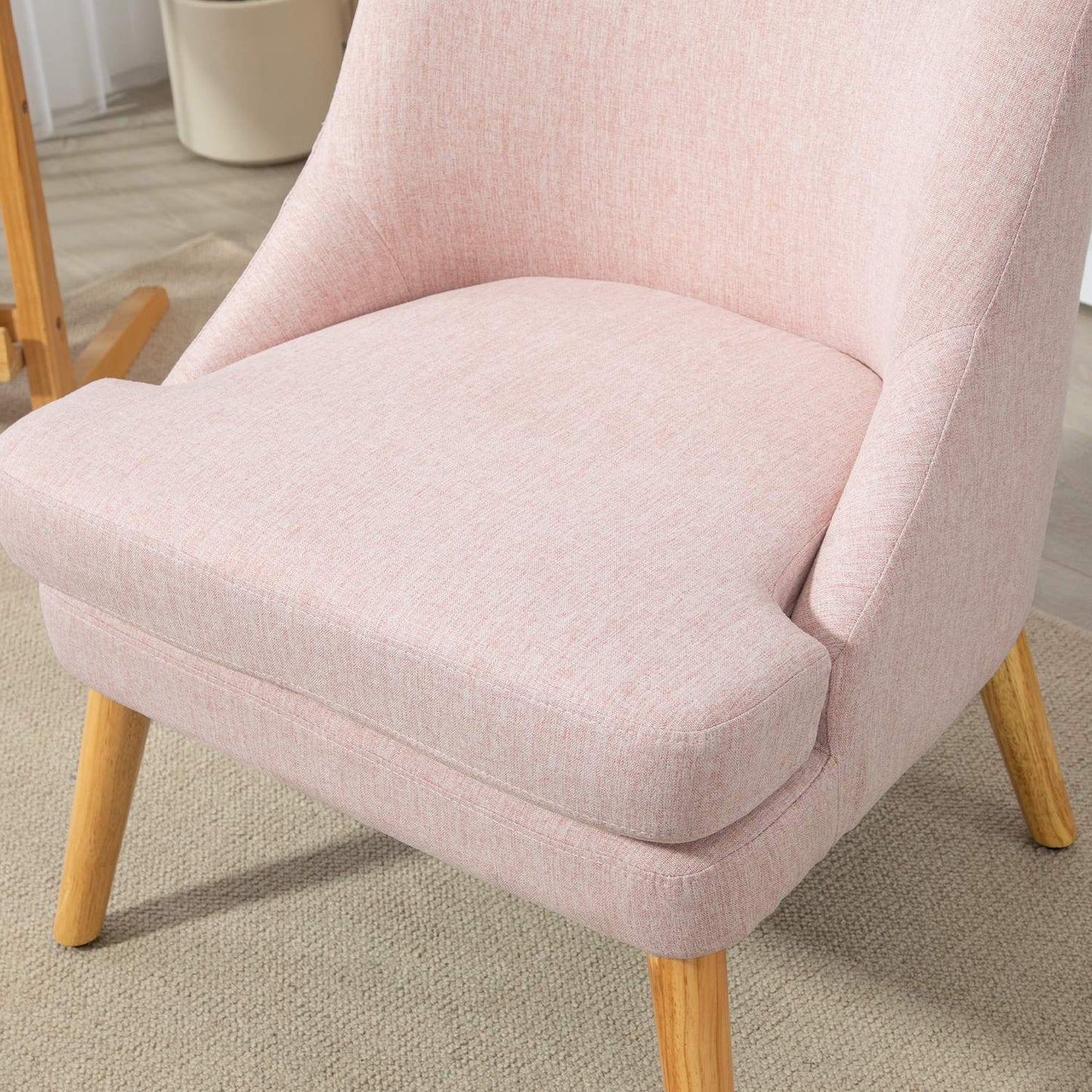 Pink lounge chair in linen look with armrests, wooden legs