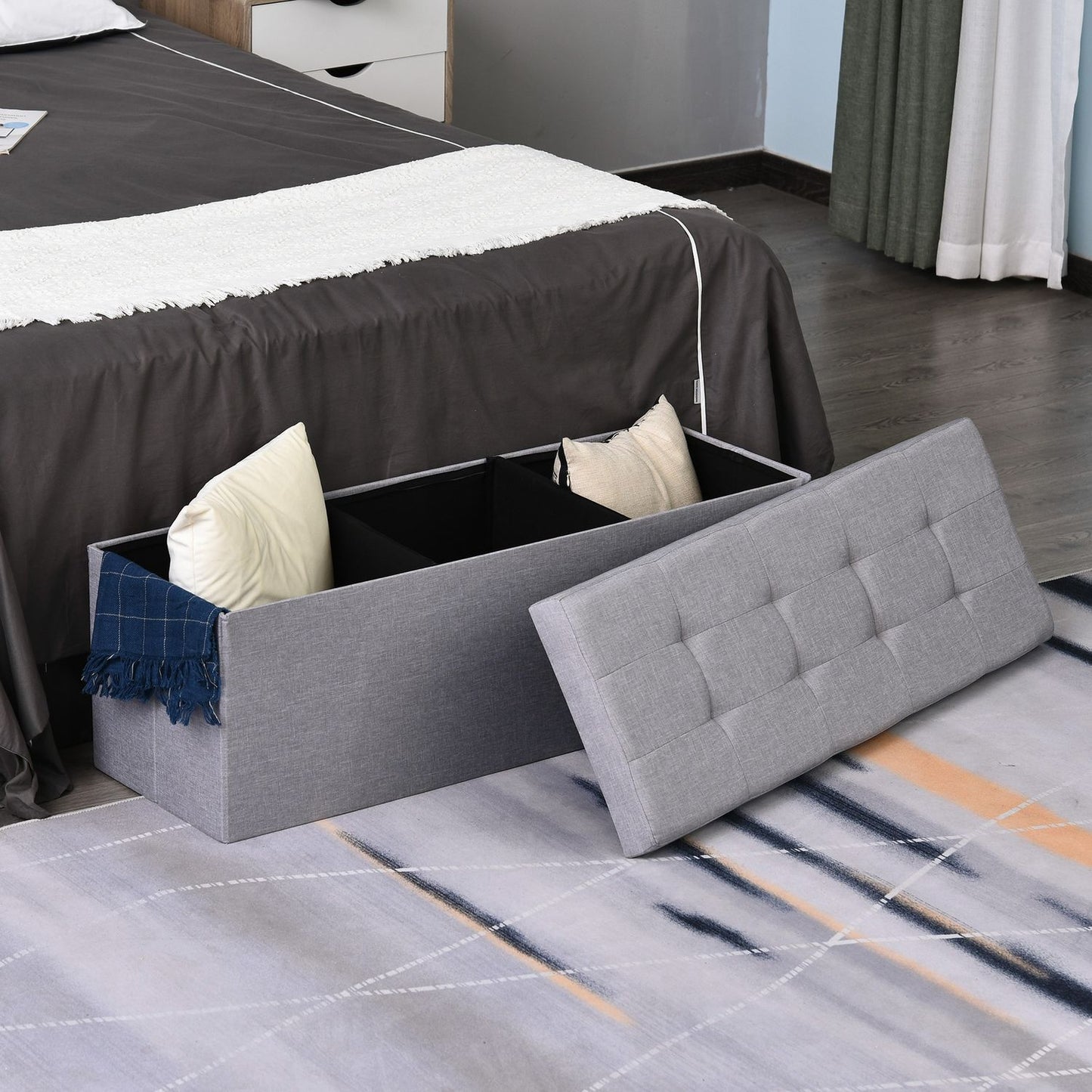 Gray upholstered storage bench, foldable with dividers