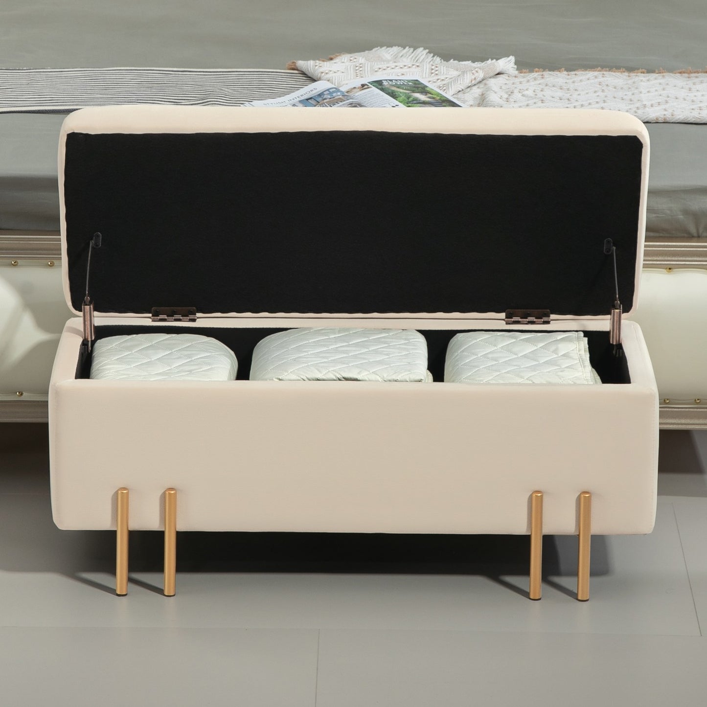 Beige velvet covered storage bench with wooden legs