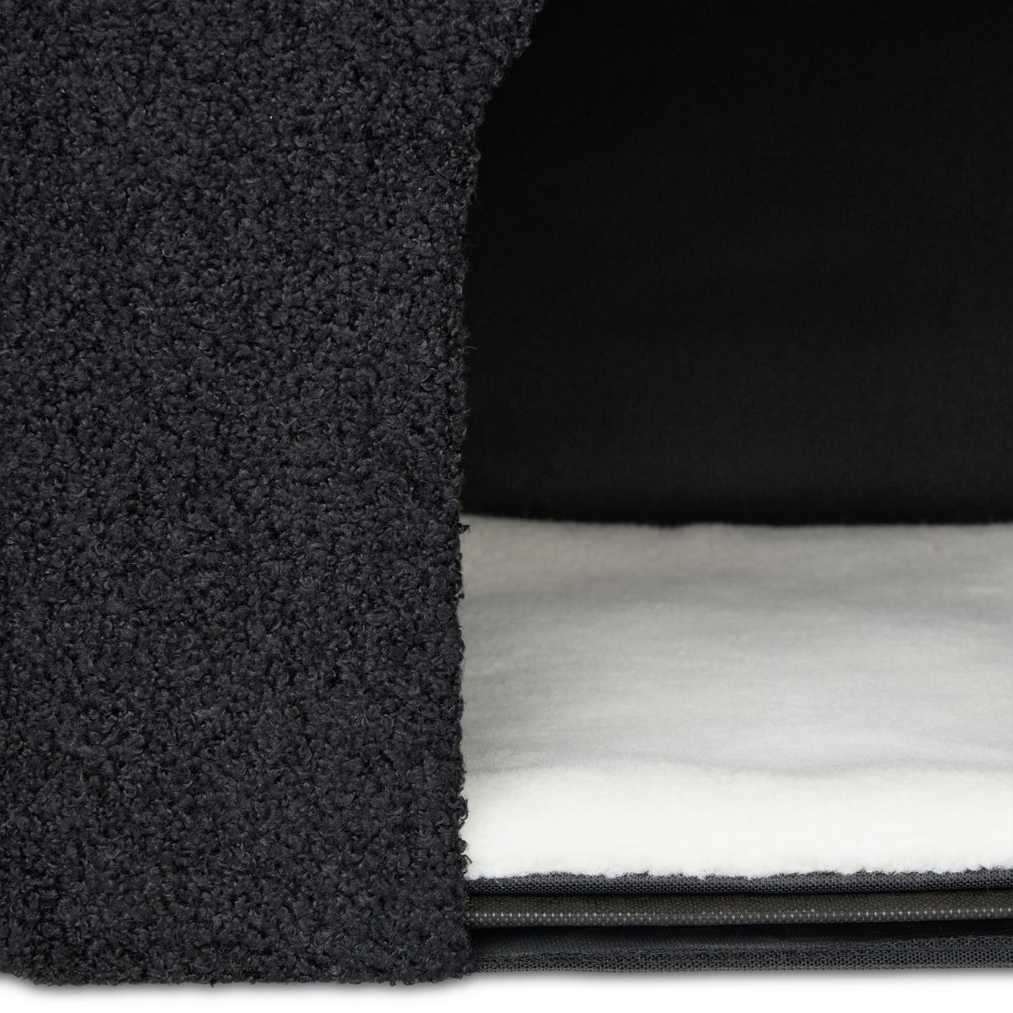 Black cat hide with scratching surface