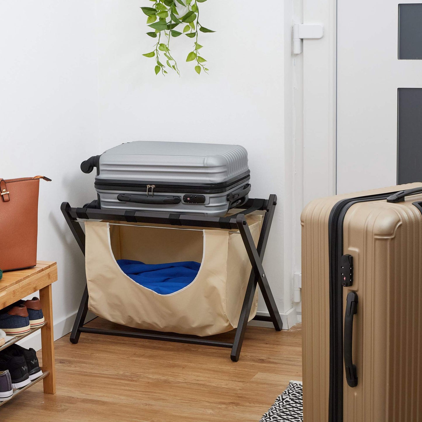 Black suitcase rack with laundry bag