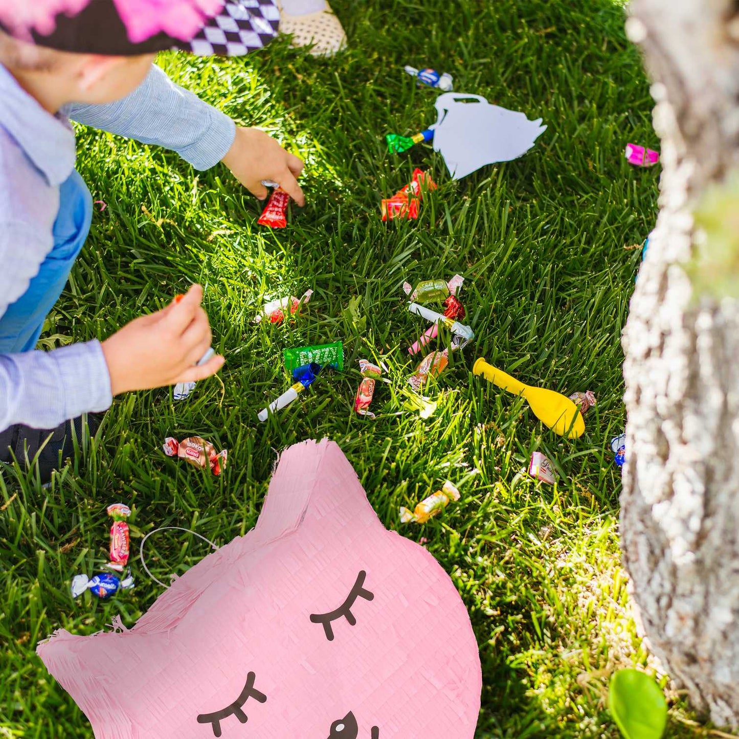 Cat pinata with lollipop and worm