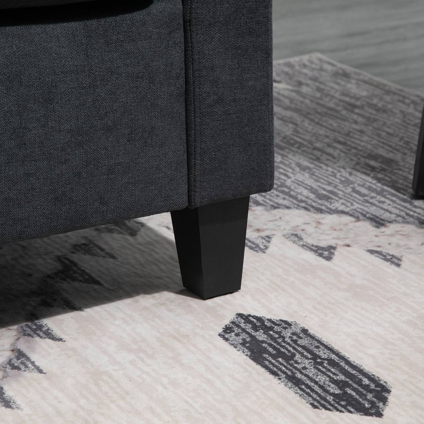 Dark gray reversible L-shaped fabric sofa with chaise longue