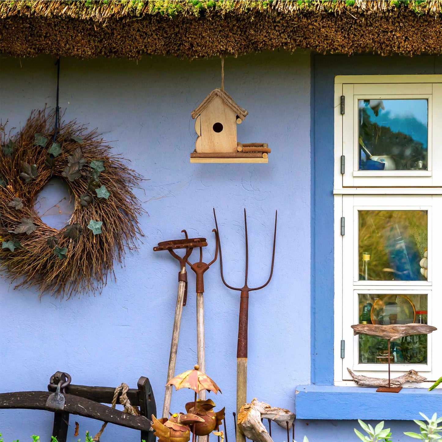 Decorative bird house with feeding station