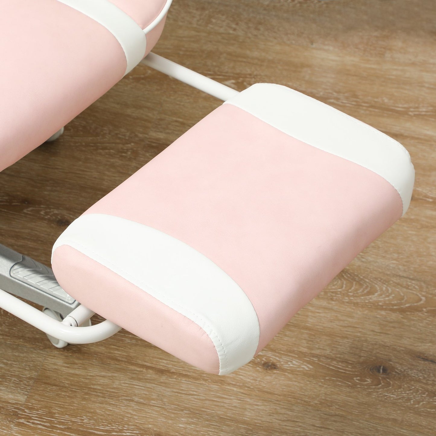 Pink gaming chair with footrest and adjustable cushions