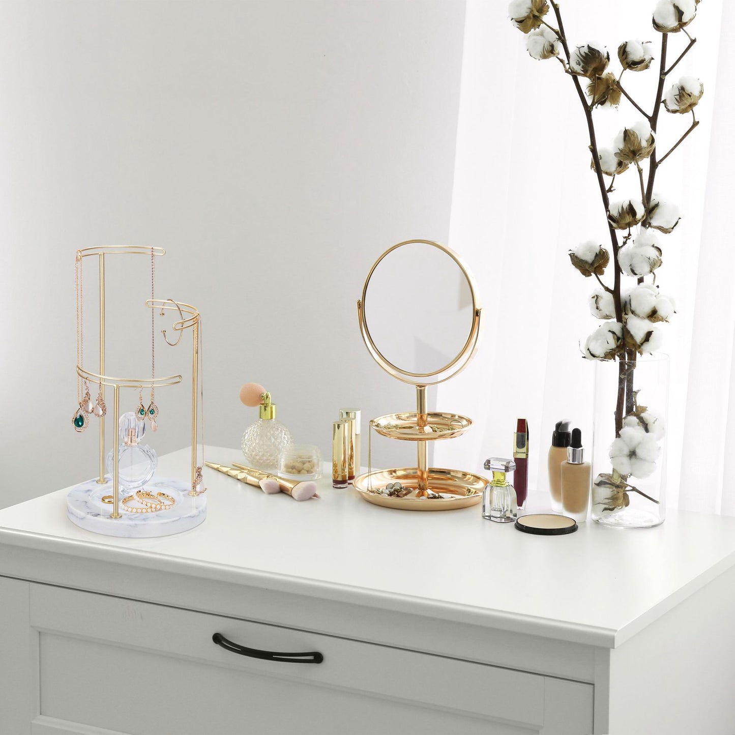 Gold colored jewelry stand with marble base