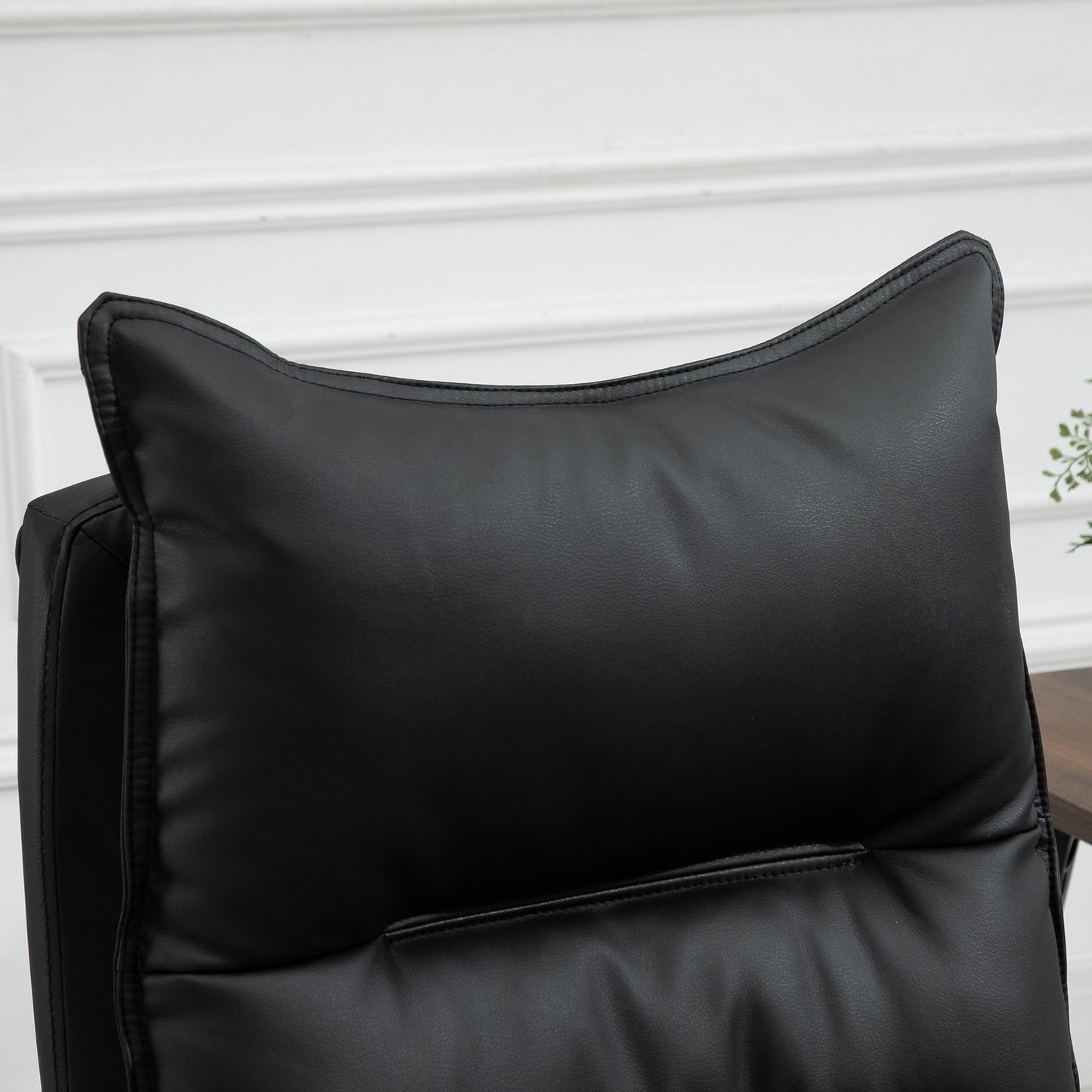Black office chair in synthetic leather with adjustable footrest