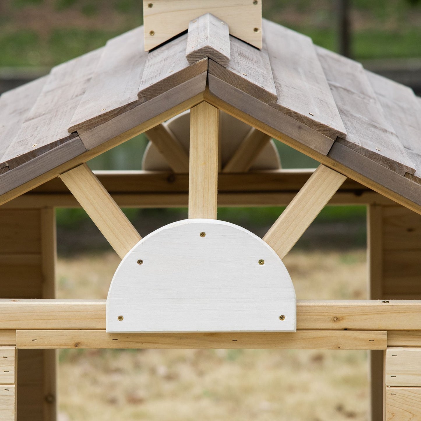 Wooden outdoor playhouse for children with flowers and mailbox