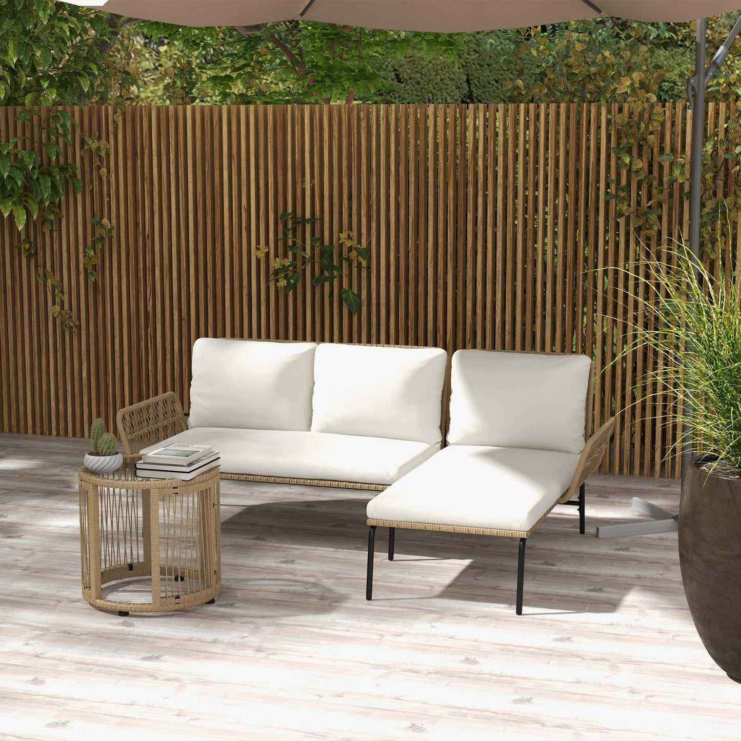 Rattan garden furniture with chair, table and cushions