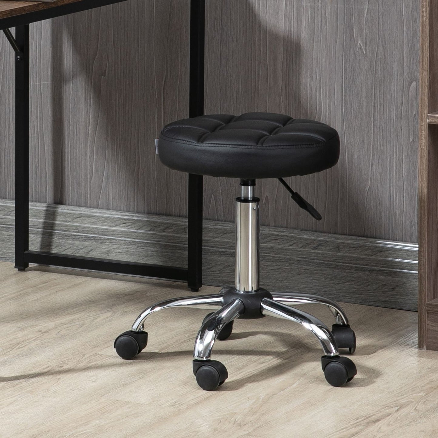 Height-adjustable salon stool in black artificial leather