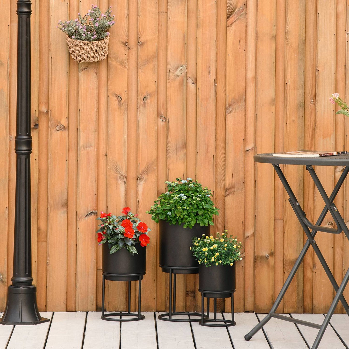 Set of 3 black stackable flower stands with pots